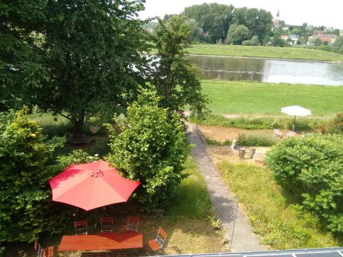 a red umbrella sitting on top of a table at Pension Elbkiosk in Kleinzadel