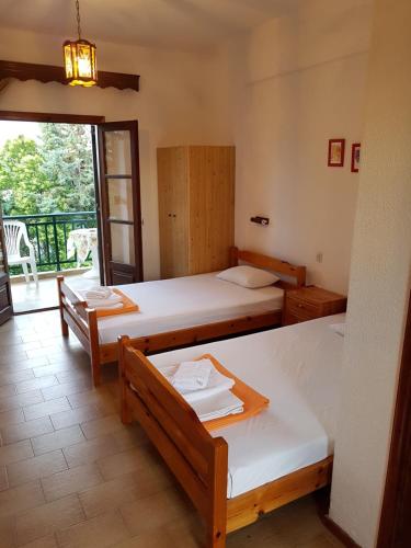 a room with two beds and a balcony at Panorama in Kallithea Halkidikis