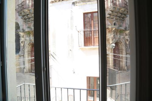 an open window with a view of a building at Intervallo Boutique Hotel in Ragusa
