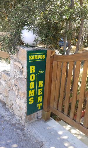 a sign for a bar for sale next to a fence at Kampos Rooms in Palaiochóra