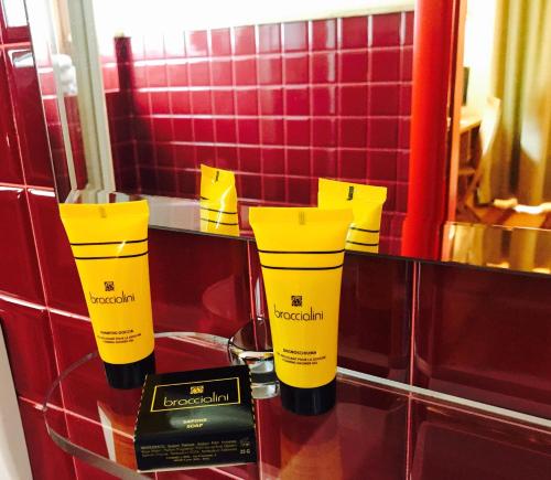two yellowodorants on a counter in a bathroom at Shatush Hotel in Courmayeur