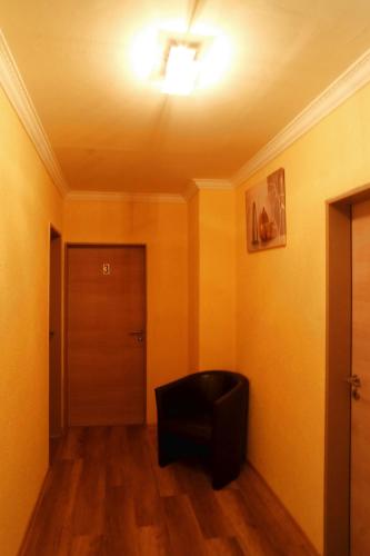a room with a black chair and a door at Gaststätte Schwenksaal in Bayreuth