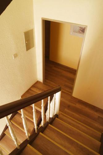 a view of a staircase in a room with wood floors at Gaststätte Schwenksaal in Bayreuth