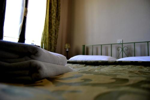 a bedroom with a bed and a window with two beds at Filoxenia Studios in Galaxidi