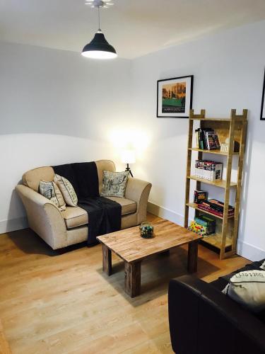 a living room with a couch and a coffee table at Posthouse in Alnwick