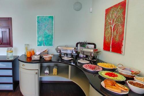 a kitchen with many plates of food on a counter at Kalvín Restaurant & Pension in Rastislavice