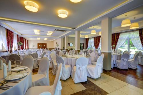 a banquet hall with white tables and chairs at Biały Pałac Palczew in Palczew