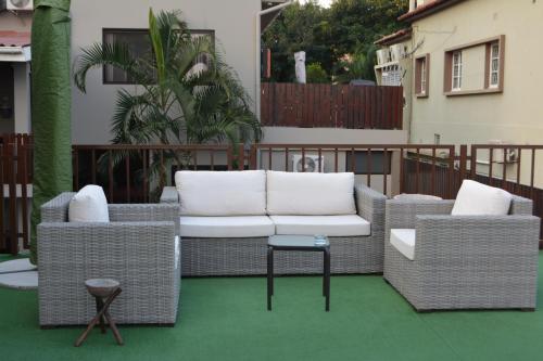 a patio with two chairs and a table on a balcony at GuestHouse 1109 in Maputo