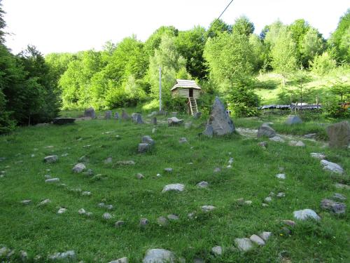 a grassy field with rocks and a gazebo at To Lem Ande in Lumshory