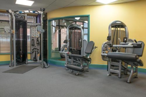 a gym with tread machines and a mirror at De Vere Latimer Estate in Chesham