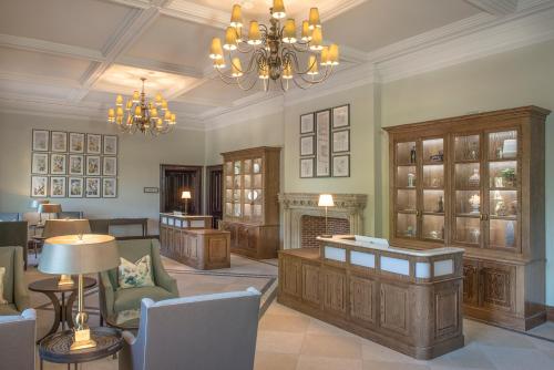 a living room with a fireplace and a chandelier at De Vere Latimer Estate in Chesham