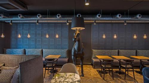 a restaurant with a horse head on the wall at ibis Styles Laval Centre Gare in Laval