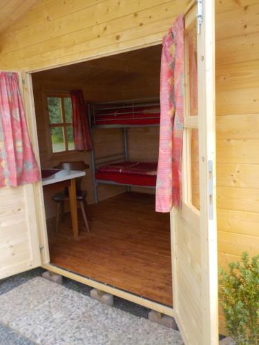 a inside view of a wooden cabin with a bunk bed at Gasthaus Zehrermühle in Schönberg