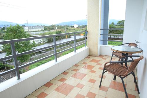 a balcony with a table and chairs and a view at Mei Shiou B&B in Dongshan