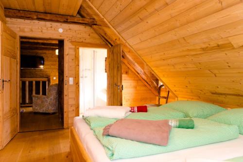 a bedroom with two beds in a log cabin at Baumgartner - Bauernhaus in Weißkirchen in Steiermark