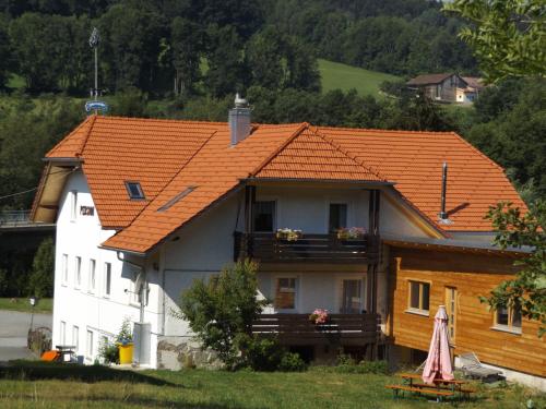 a white house with an orange roof at Gasthaus Zehrermühle in Schönberg