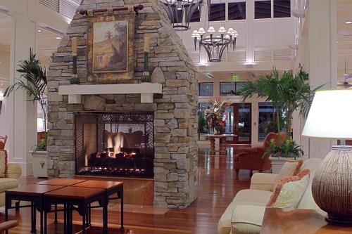 a living room with a stone fireplace in a lobby at Hyatt Vacation Club at Coconut Cove in Bonita Shores