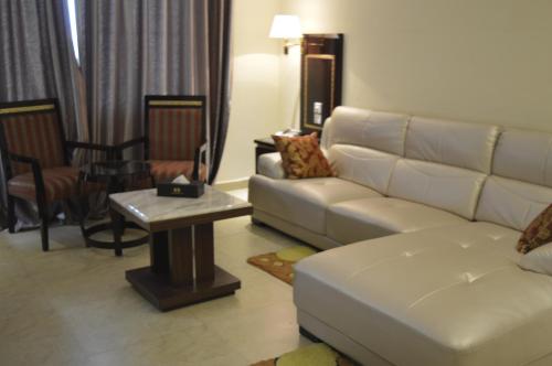 a living room with a couch and a table at Tiffany Diamond Hotels - Mtwara in Mtwara