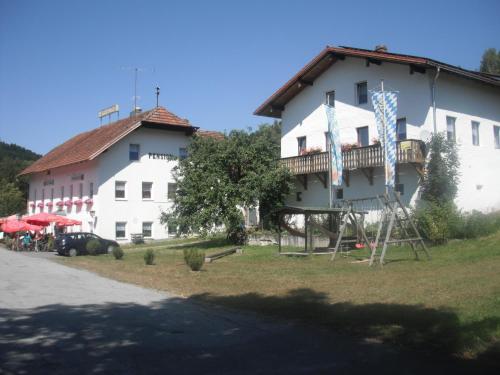 a large white building with a balcony on the side of it at Gasthaus Zehrermühle in Schönberg