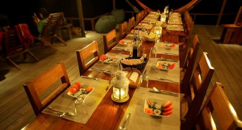a long table with plates of food on it at Hotel Finca Maresia in Drake