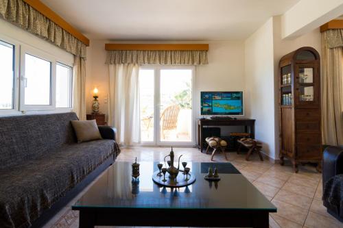 a living room with a couch and a table at Aris Palace in Elia