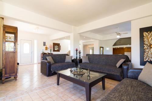 a living room with two couches and a coffee table at Aris Palace in Elia