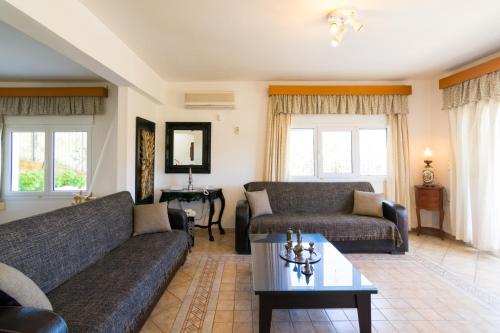 a living room with two couches and a coffee table at Aris Palace in Elia