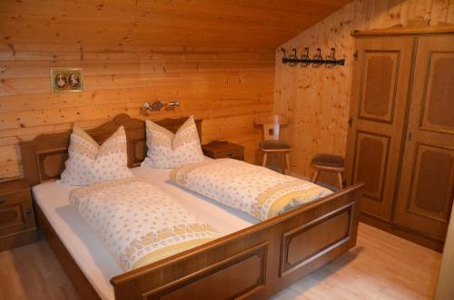a bedroom with a bed in a log cabin at Rieplerhof in Matrei in Osttirol