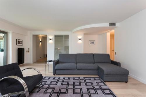 a living room with a couch and a chair at Foch triomphe in Paris