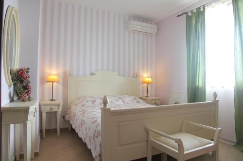 a bedroom with a bed and a chair and a window at Villa Bulgara Eco in Madara