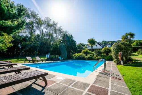 a swimming pool with a picnic table and a bench at Fleur Du Jardin in Kings Mills