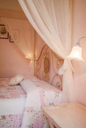 a bedroom with a bed with a canopy at B&B 8380 Saturnia Terme in Saturnia