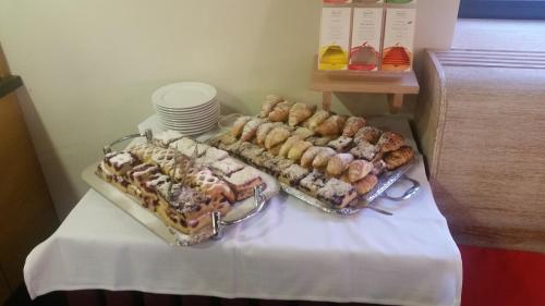 a table with several trays of pastries on it at Penzion Lípa in Krásná Lípa