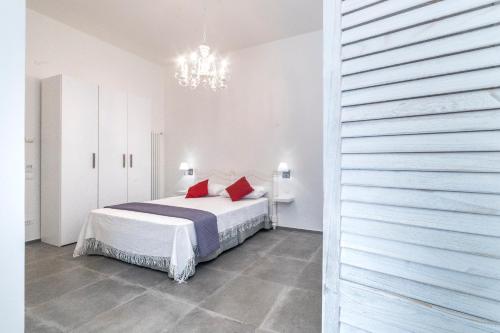 a bedroom with a bed with red pillows on it at Incentro in Gallipoli