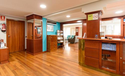 a large room with wooden floors and wooden cabinets at México PR in Santiago de Compostela