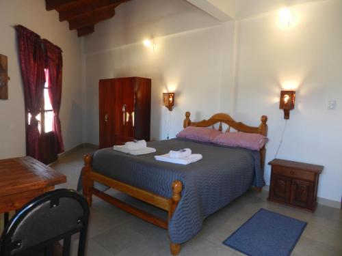 a bedroom with a bed with two towels on it at Hotel Maria Cafayate in San Carlos