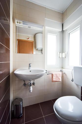 a bathroom with a sink and a toilet at Apartments Dream in Nin