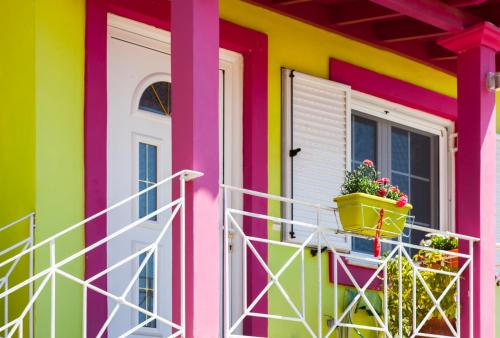 a colorful house with a window and a flower pot at Zois' House in Sívros