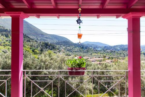 a view from the porch of a house with a flower pot at Zois' House in Sívros