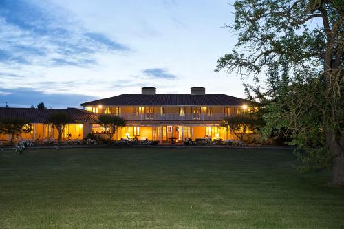 a large house with a lawn in front of it at Viña La Playa Hotel & Winery in Santa Cruz