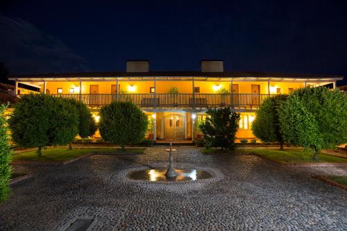a building with a fountain in front of it at night at Viña La Playa Hotel & Winery in Santa Cruz