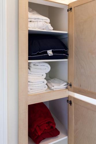 a cupboard filled with lots of towels at Heaven On Baltimore Downtown Fully Furnished Apartments in Baltimore