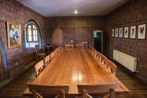 a large wooden table in a room with chairs at Viña La Playa Hotel & Winery in Santa Cruz