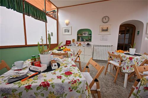 a kitchen with a table and chairs and a kitchen with a tableablish at Hotel Carmel in Rome