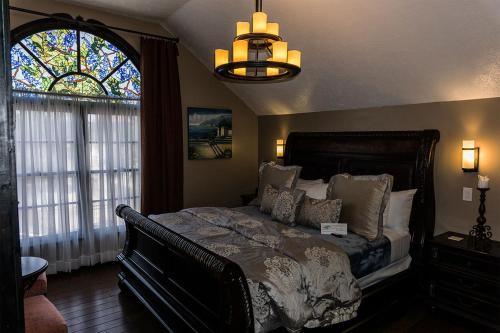 a bedroom with a bed and a stained glass window at Old City House Inn and Restaurant in St. Augustine