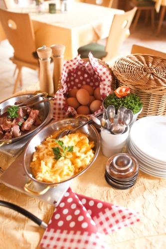a table topped with dishes of food on a table at Hotel zur Post in Lam