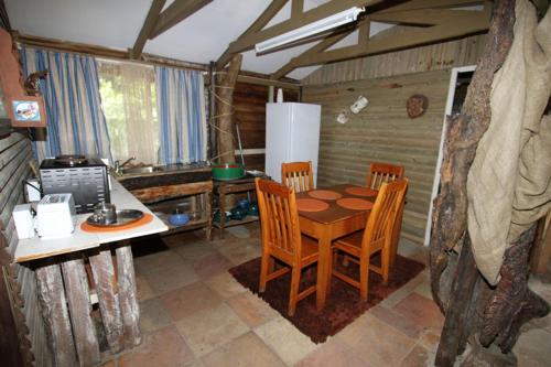 a kitchen with a table and chairs in a room at Tugela Mouth Resort in Tugela Mouth