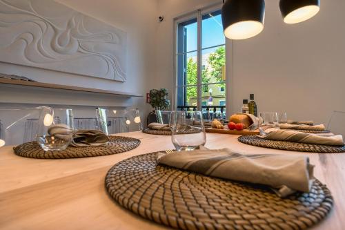a table with plates and glasses on top of it at Sodium Boutique Hotel in Ciutadella
