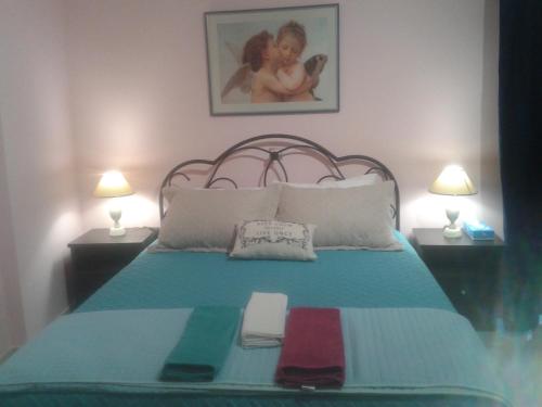 a bedroom with a bed with two towels on it at Super 36sqm Junior Suite in luxurious picturesque area in Piraeus