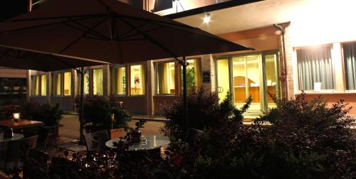 a patio with an umbrella in front of a building at Best Western Hotel I Colli in Macerata